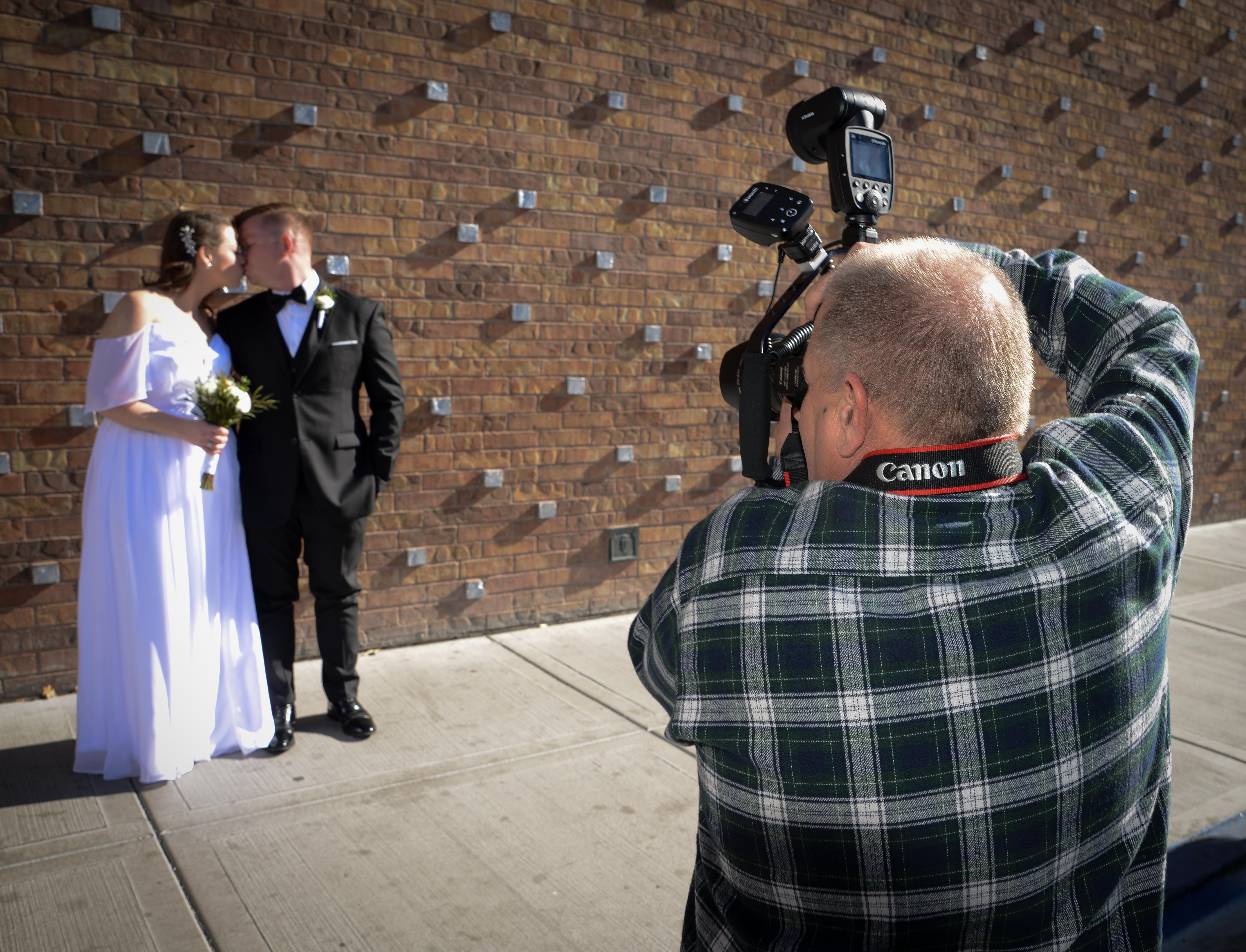 Jack Vosburgh in Fremont Street with wedding couple